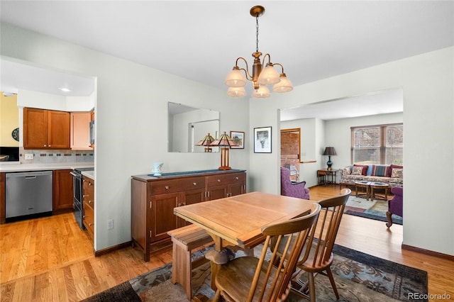 3151 E 134th Cir, Thornton, CO 80241 - dining room featuring light wood-style flooring and a chandelier