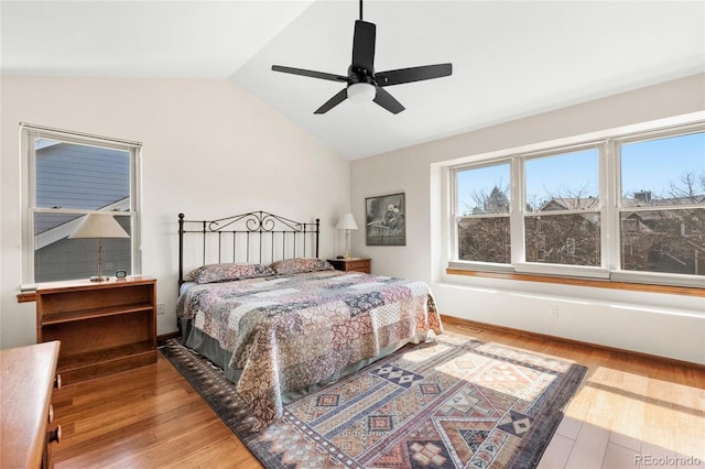 3151 E 134th Cir, Thornton, CO 80241 - bedroom with vaulted ceiling, wood finished floors, a ceiling fan, and baseboards