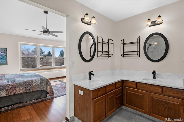3151 E 134th Cir, Thornton, CO 80241 - bathroom featuring a ceiling fan, double vanity, and wood finished floors