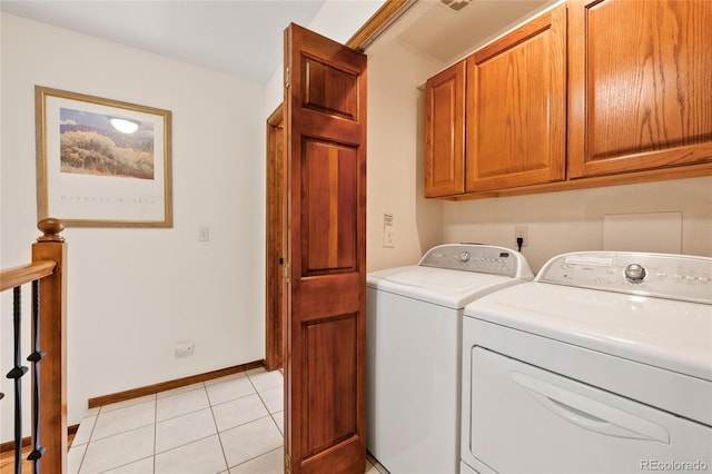 3151 E 134th Cir, Thornton, CO 80241 - washroom featuring washer and dryer, cabinet space, baseboards, and light tile patterned floors