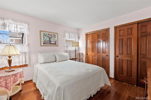 3151 E 134th Cir, Thornton, CO 80241 - bedroom with two closets, wood finished floors, and baseboards