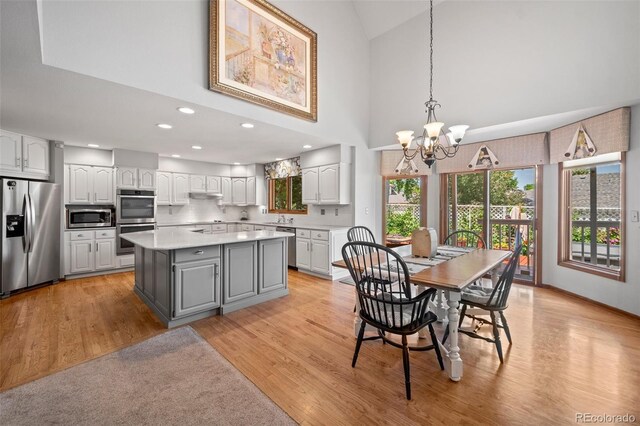 4161 W Lake Cir N, Littleton, CO 80123 - dining space featuring a chandelier, light wood-style floors, recessed lighting, and high vaulted ceiling