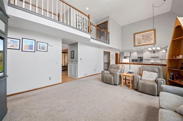 4161 W Lake Cir N, Littleton, CO 80123 - living room featuring a high ceiling, light colored carpet, baseboards, and a chandelier