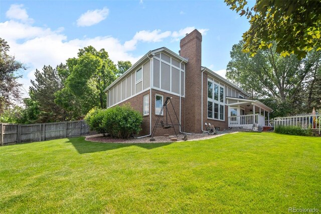 4161 W Lake Cir N, Littleton, CO 80123 - back of property with a chimney, brick siding, and a porch