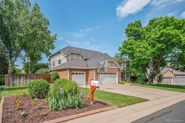 4161 W Lake Cir N, Littleton, CO 80123 - view of front facade featuring brick siding, driveway, roof with shingles, and an attached garage