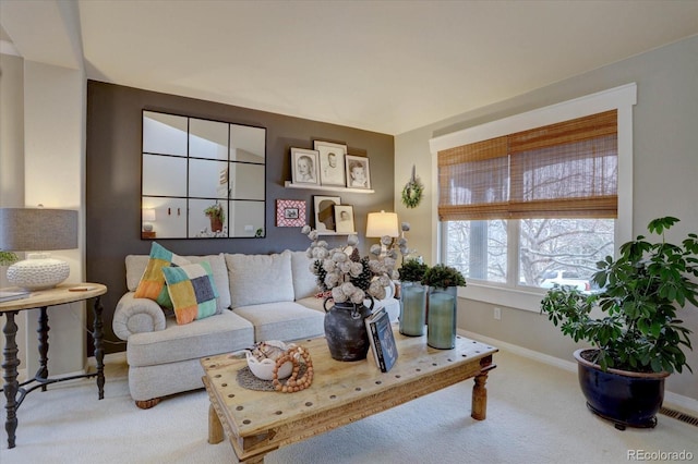 living area featuring baseboards, visible vents, and carpet floors