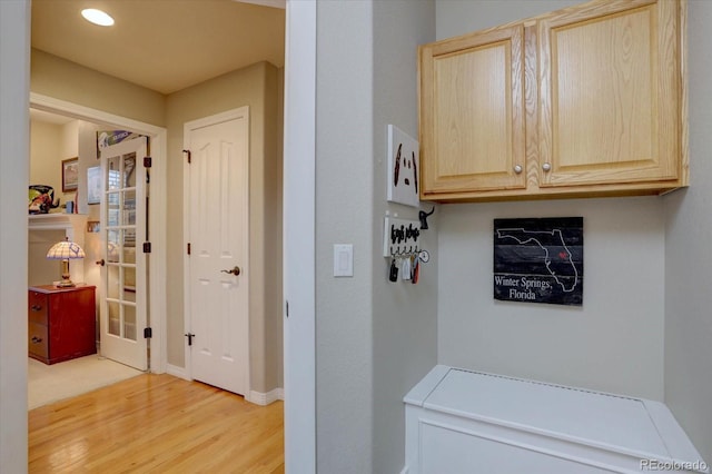 laundry room featuring light wood-style floors