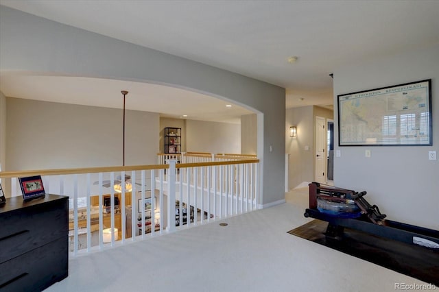 hallway featuring carpet floors and baseboards