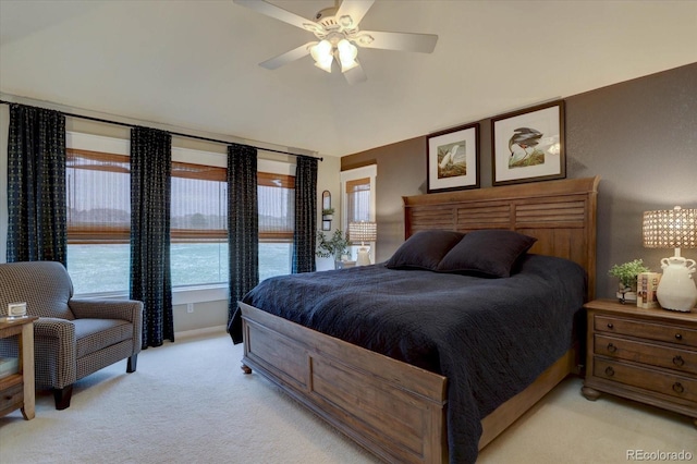 bedroom with ceiling fan, vaulted ceiling, and light colored carpet
