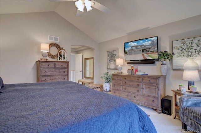 carpeted bedroom with visible vents, arched walkways, lofted ceiling, and a ceiling fan