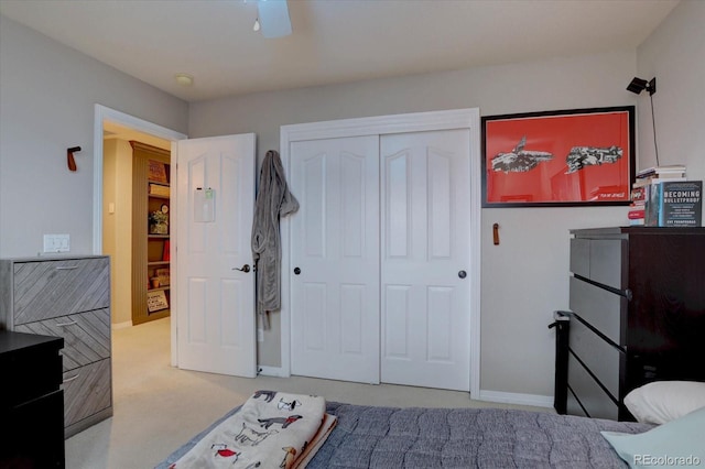 bedroom featuring baseboards, a closet, and carpet