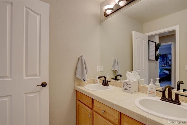 bathroom featuring double vanity and a sink