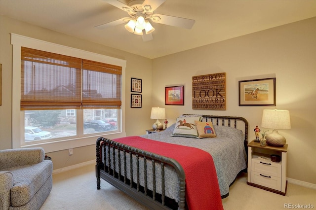 bedroom featuring baseboards, a ceiling fan, and light carpet