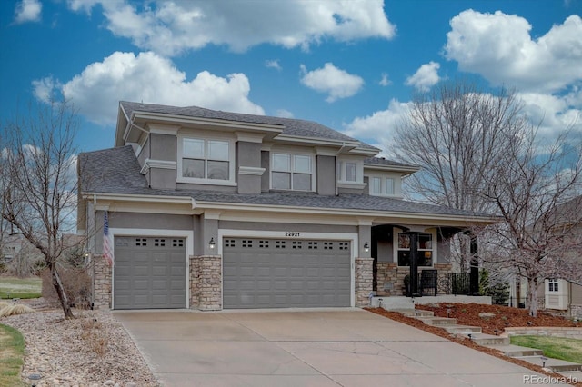 prairie-style house with stone siding, driveway, a garage, stucco siding, and a porch