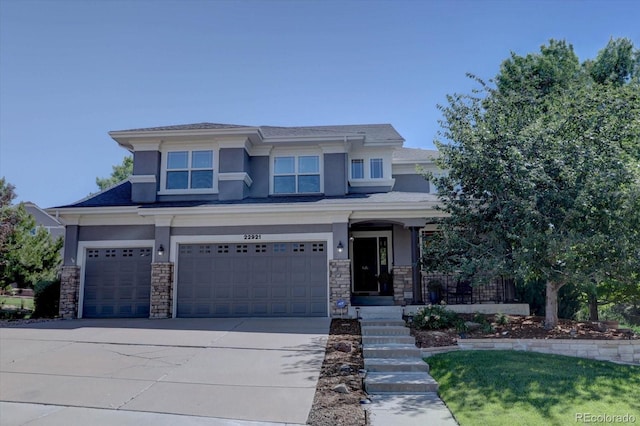 22921 E Euclid Cir, Aurora, CO 80016 - prairie-style house featuring stucco siding, a garage, stone siding, and driveway