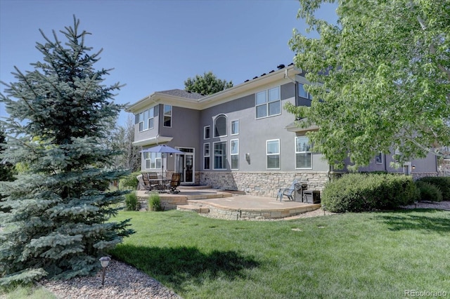22921 E Euclid Cir, Aurora, CO 80016 - rear view of property featuring a patio, a yard, stucco siding, and stone siding