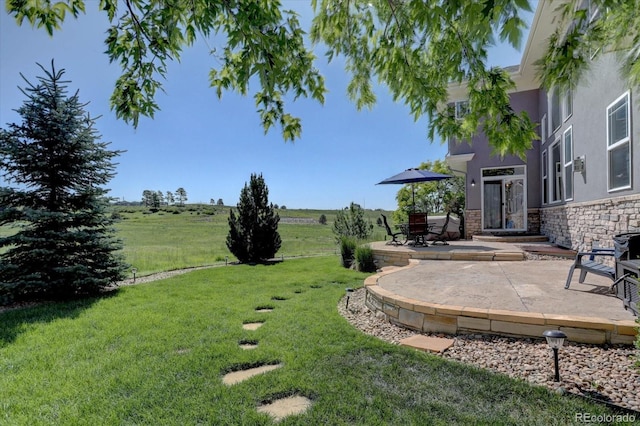 22921 E Euclid Cir, Aurora, CO 80016 - view of grassy yard with a patio area