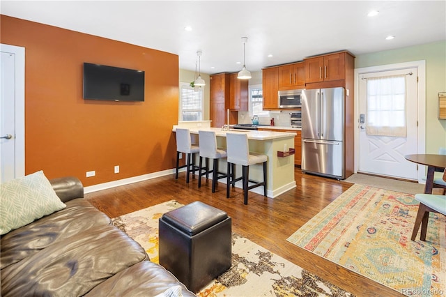 living room featuring dark wood finished floors, baseboards, plenty of natural light, and recessed lighting