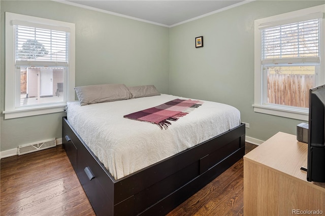 bedroom with baseboards, ornamental molding, visible vents, and dark wood-type flooring