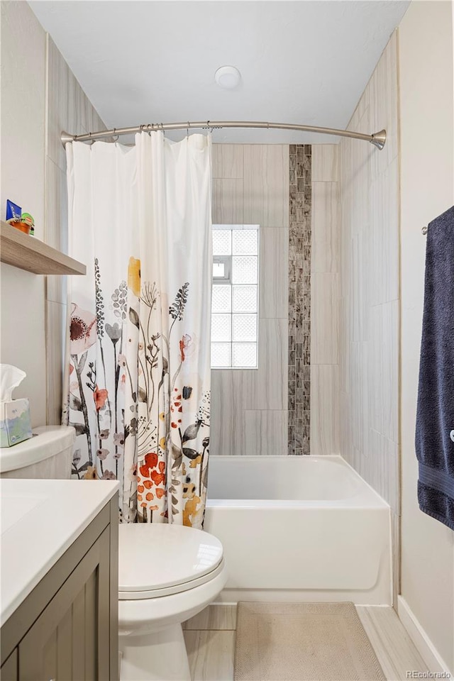 bathroom with vanity, toilet, and shower / bath combo with shower curtain