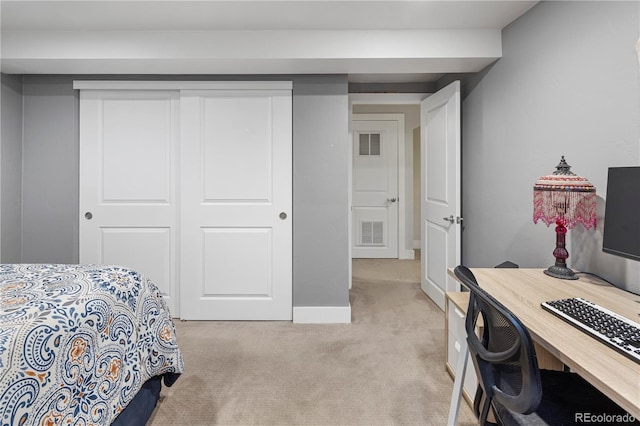 bedroom with visible vents, a closet, and light carpet