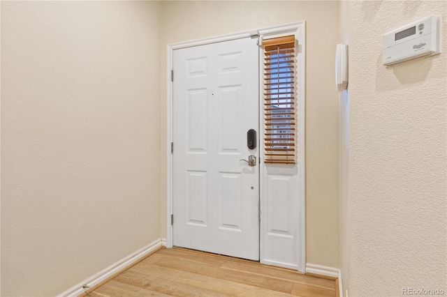 3000 E 112th Ave Unit 102, Northglenn, CO 80233 - foyer with light wood-type flooring and a textured wall