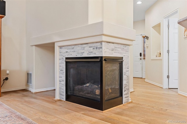 3000 E 112th Ave Unit 102, Northglenn, CO 80233 - detailed view of a fireplace, wood finished floors, and recessed lighting