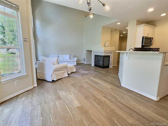 3000 E 112th Ave Unit 102, Northglenn, CO 80233 - living area with light wood-type flooring, recessed lighting, and a tile fireplace