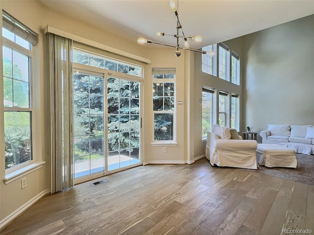 3000 E 112th Ave Unit 102, Northglenn, CO 80233 - entryway featuring hardwood / wood-style flooring and a chandelier