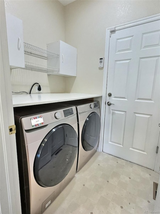 3000 E 112th Ave Unit 102, Northglenn, CO 80233 - laundry area with washer and clothes dryer and light flooring