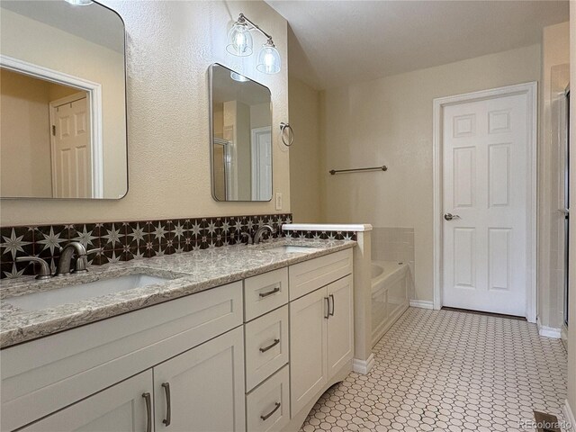 3000 E 112th Ave Unit 102, Northglenn, CO 80233 - full bath featuring double vanity, a bath, a shower with door, and decorative backsplash