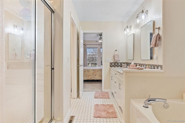 3000 E 112th Ave Unit 102, Northglenn, CO 80233 - ensuite bathroom featuring a stall shower, vanity, a garden tub, and tile patterned flooring