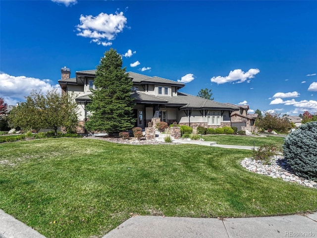 prairie-style home featuring a front lawn