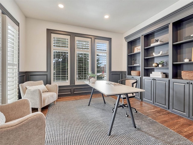 home office featuring built in features and dark hardwood / wood-style flooring