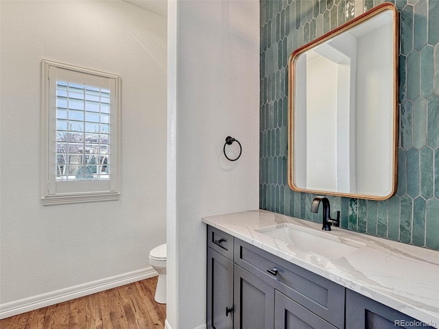 bathroom featuring vanity, toilet, and hardwood / wood-style floors