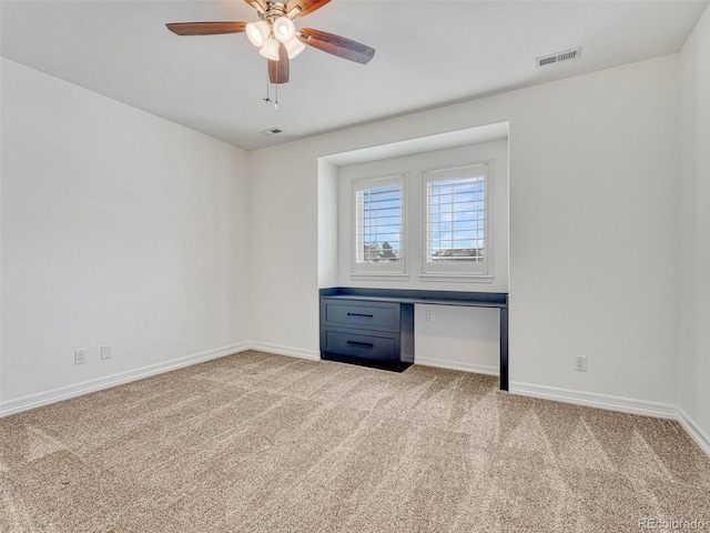 carpeted empty room featuring ceiling fan