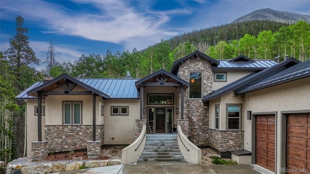 25735 County Road 295, Nathrop, CO 81236 - view of front facade with a standing seam roof, stucco siding, stone siding, and a metal roof
