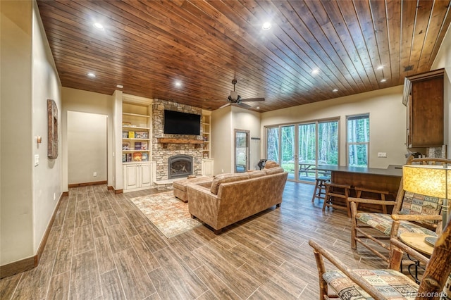 25735 County Road 295, Nathrop, CO 81236 - living room featuring wood ceiling, a ceiling fan, a fireplace, built in shelves, and wood finished floors