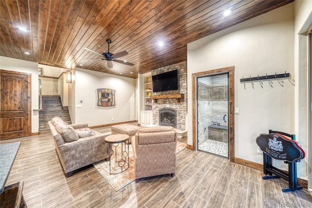 25735 County Road 295, Nathrop, CO 81236 - living room featuring wood finish floors, wooden ceiling, ceiling fan, a stone fireplace, and stairway