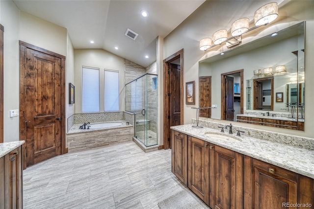 25735 County Road 295, Nathrop, CO 81236 - bathroom with vanity, a bath, a shower stall, vaulted ceiling, and recessed lighting