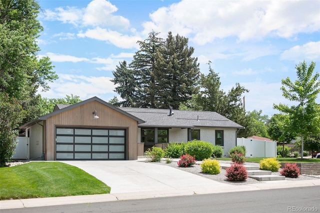 2998 S Adams St, Denver, CO 80210 - view of front facade with a garage and driveway