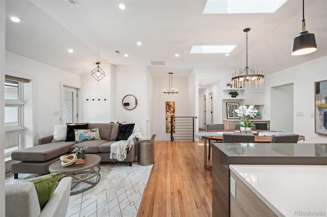 2998 S Adams St, Denver, CO 80210 - living area with a skylight, lofted ceiling, light wood-style flooring, a chandelier, and recessed lighting