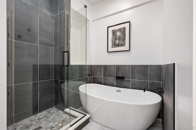 2998 S Adams St, Denver, CO 80210 - full bathroom with a soaking tub, a stall shower, marble finish floors, and tile walls