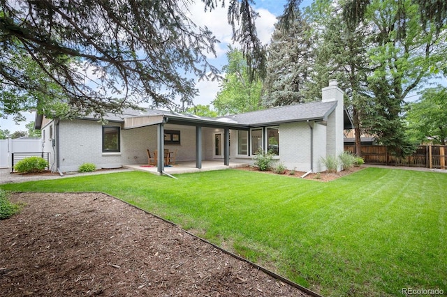 2998 S Adams St, Denver, CO 80210 - rear view of house featuring brick siding, a chimney, a fenced backyard, and a patio area