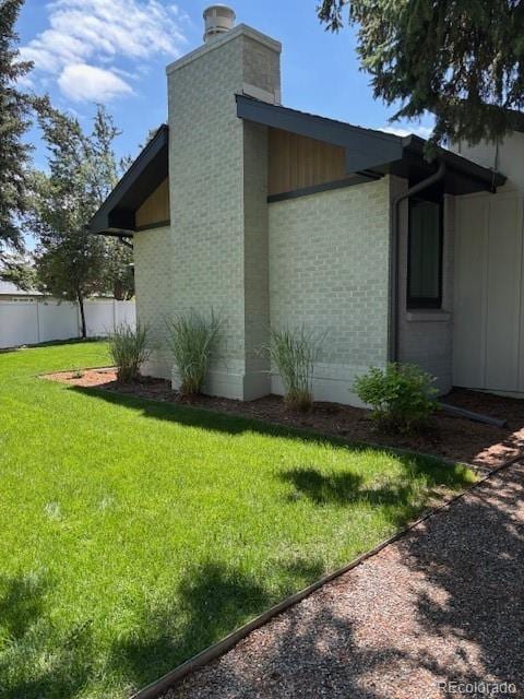 2998 S Adams St, Denver, CO 80210 - view of side of property with a chimney and brick siding