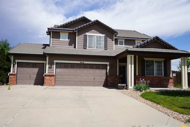 9616 Nucla St, Commerce City, CO 80022 - view of front of home featuring brick siding, a tiled roof, driveway, and a garage