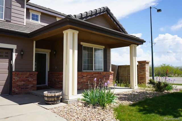 9616 Nucla St, Commerce City, CO 80022 - view of exterior entry featuring brick siding and a tiled roof