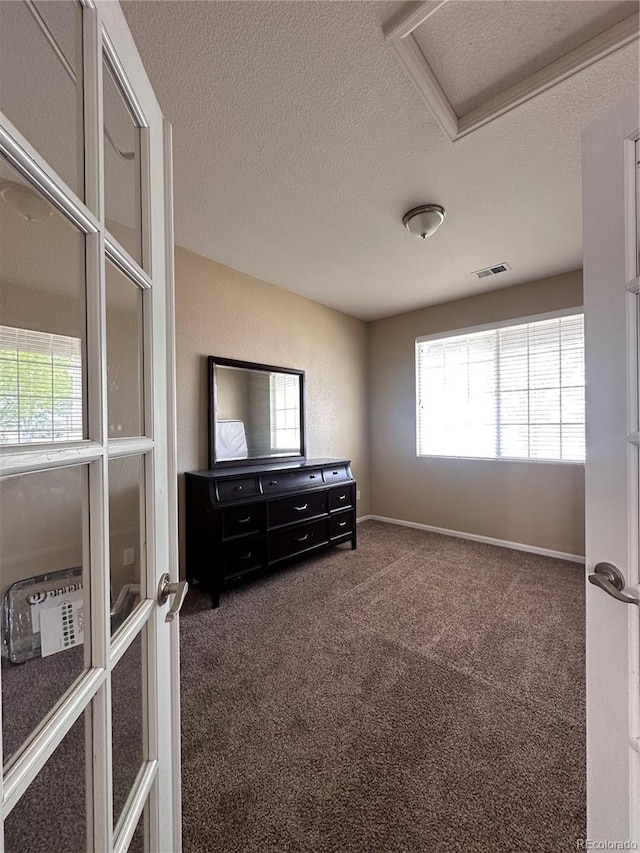 9616 Nucla St, Commerce City, CO 80022 - unfurnished room featuring attic access, a textured ceiling, and dark carpet