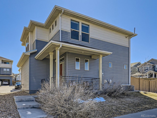 view of front of property featuring fence and a porch