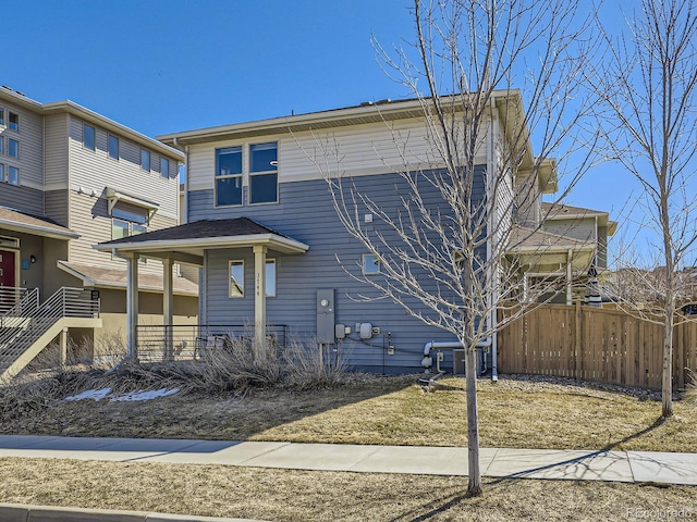 view of front of property with covered porch and fence